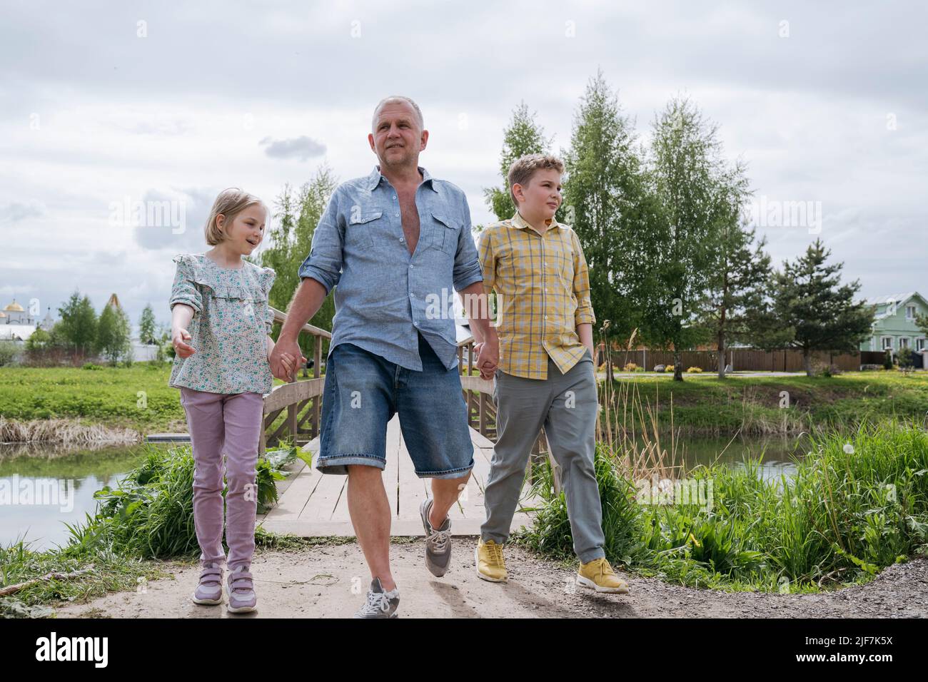 The father walks with the children in nature Stock Photo - Alamy