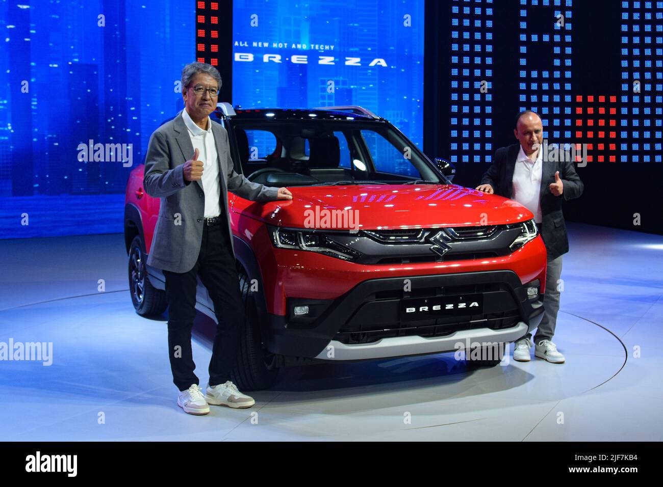 Gurugram, Haryana, India. 30th June, 2022. Managing Director & CEO Maruti Suzuki India Limited Hisashi Takeuchi (L) and Executive Director Shashank Srivastava (R) pose for pictures with the newly launched Maruti Suzuki Brezza during its launch event at Gurugram, India. (Credit Image: © Kabir Jhangiani/Pacific Press via ZUMA Press Wire) Stock Photo