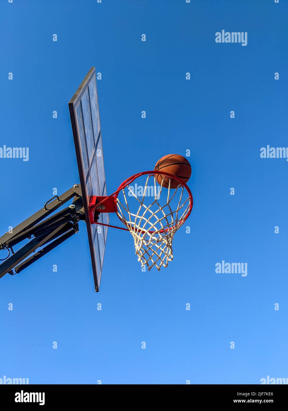 Ball in a basket against a clear sky Stock Photo