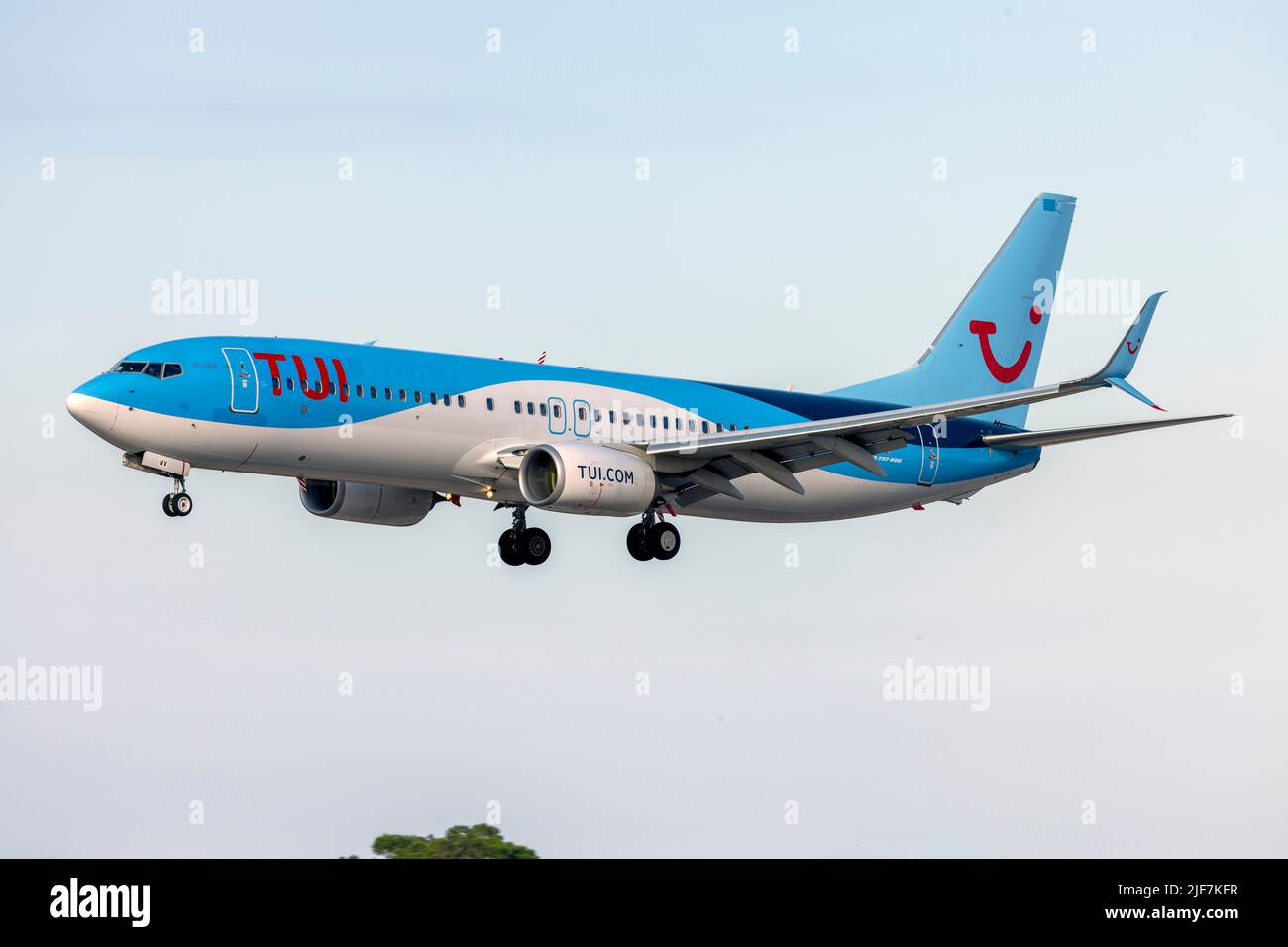 Sunwing Airlines (TUI) Boeing 737-8K5 (REG: G-TAWV) on finals runway 31. Sunwing titles still visible under the TUI logo. Stock Photo