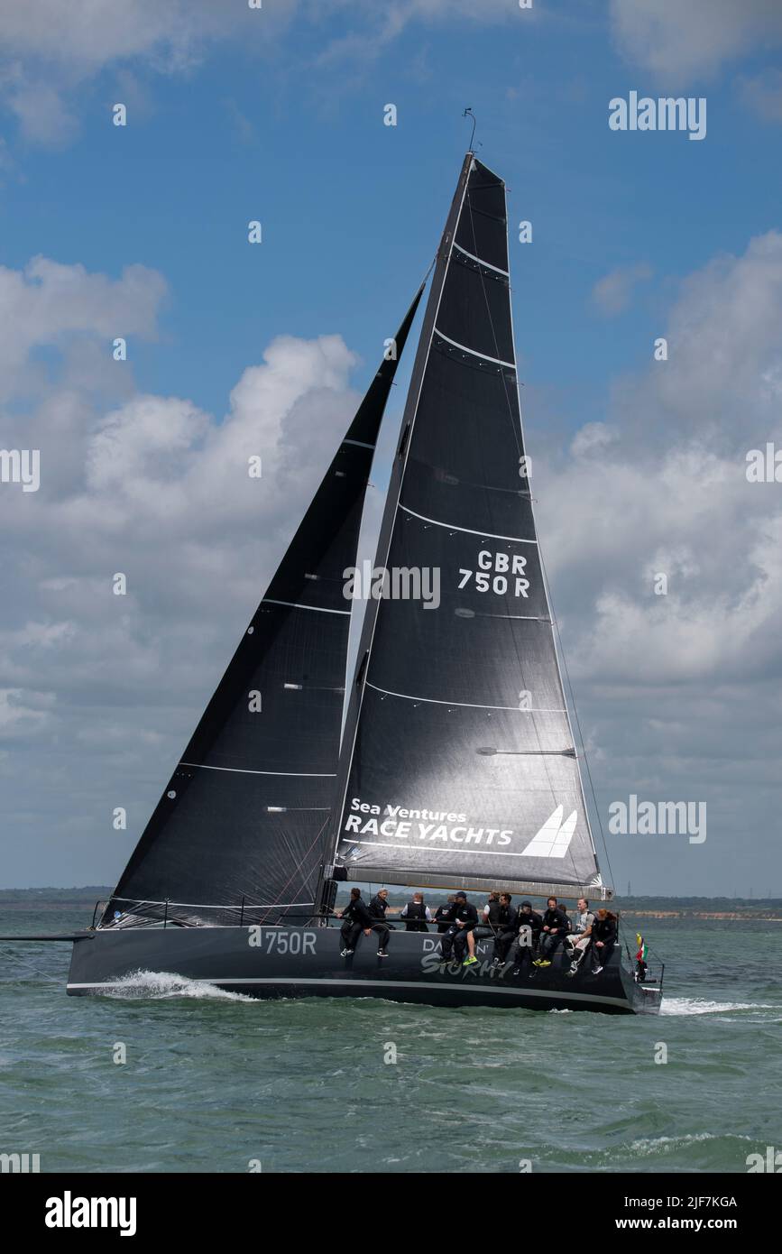 Dark N Stormy a C42 Sailing Yacht heads West along the Solent in Southern England to take the win at the Round The Island Race Stock Photo