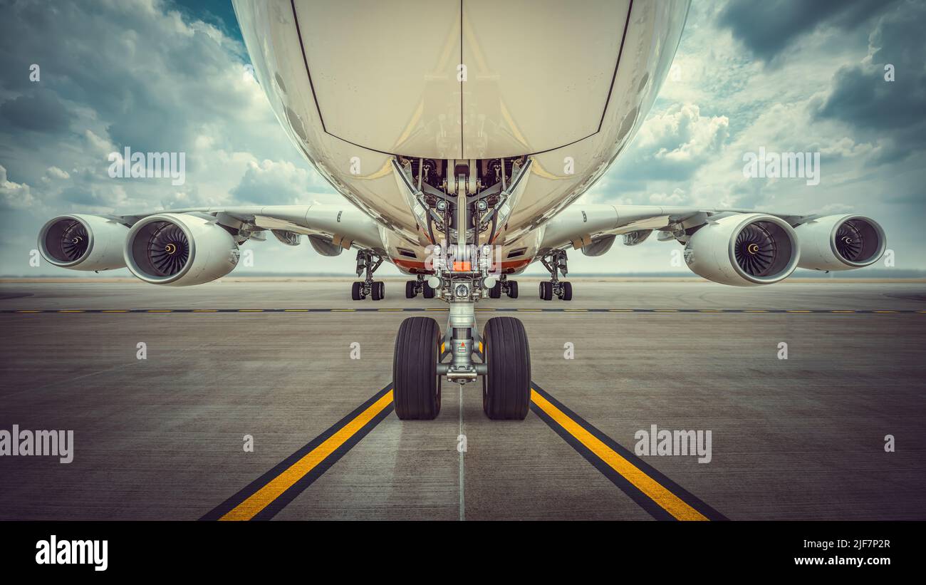 modern airliner on a runway against a dramatic sky Stock Photo