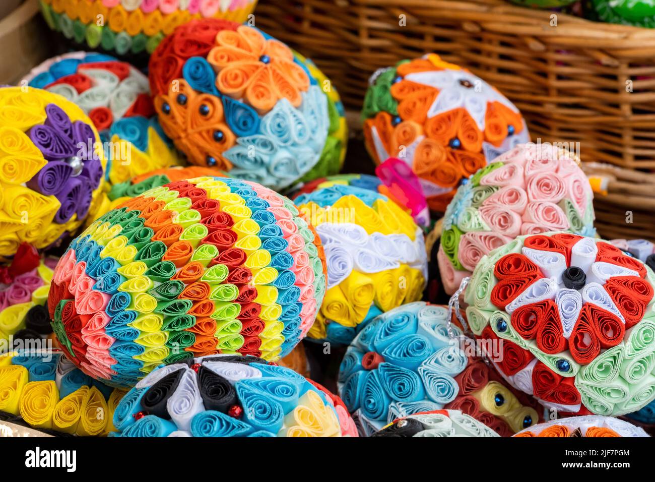 Set of colorful handmade Easter eggs in a basket, group of handcrafted traditional Polish pisanki, group of objects detail, closeup, nobody, Easter ho Stock Photo