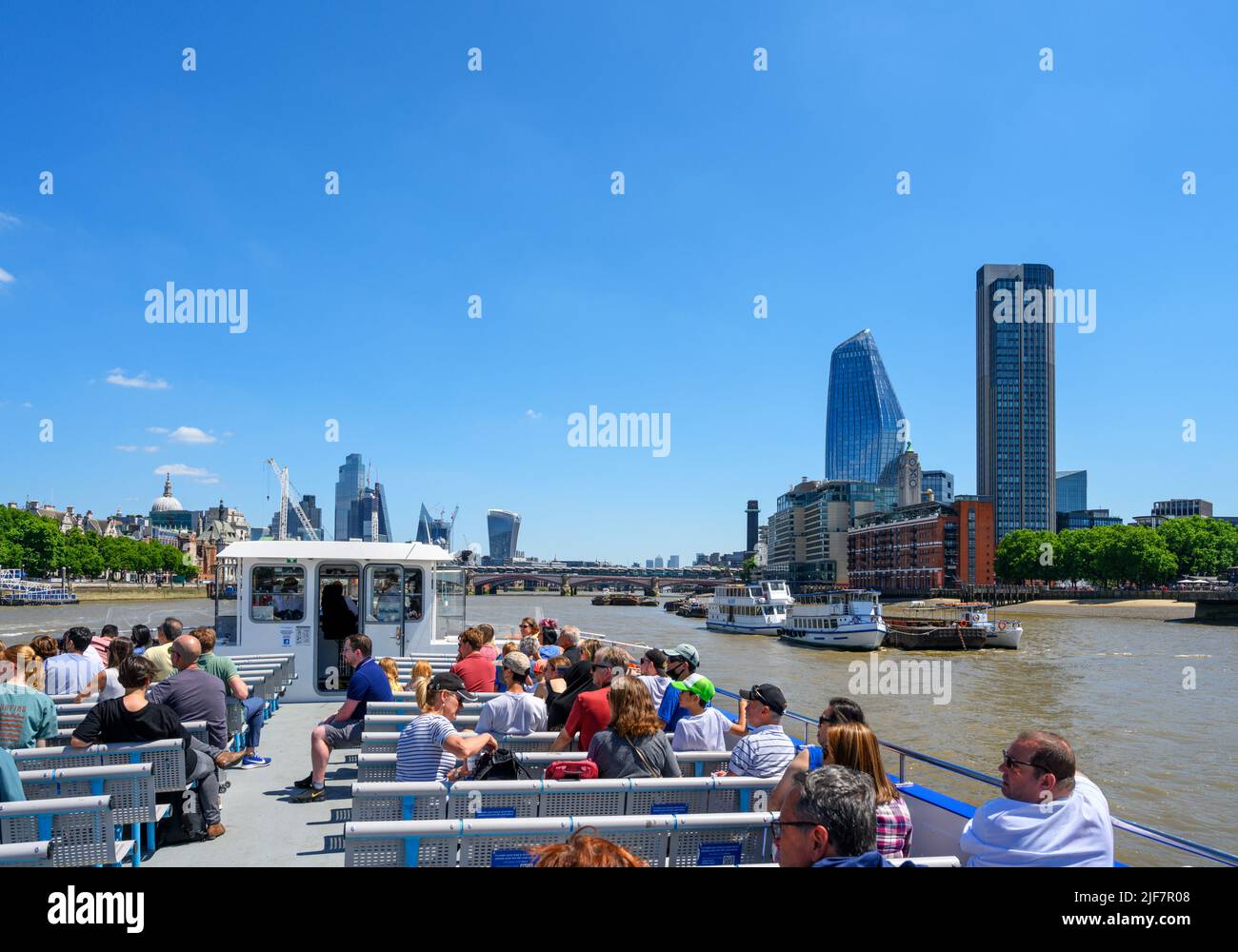 The City skyline from the deck of a City Cruises boat trip, with the South Bank Tower and One Blackfriars to the right, River Thames, London, UK Stock Photo