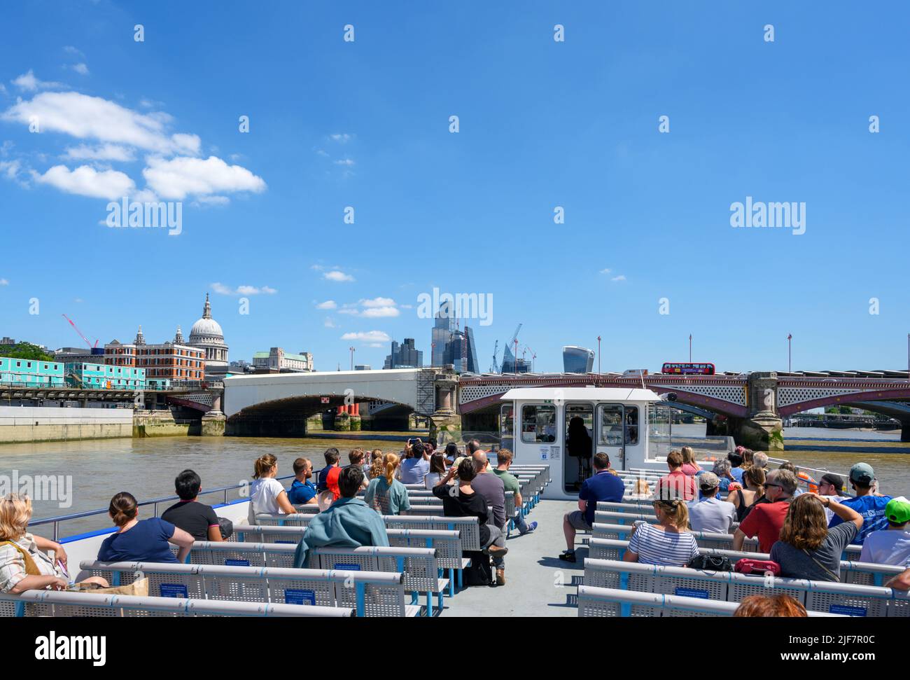 The City skyline from the deck of a City Cruises boat trip, with Blackfriars Bridge in the foreground and St Paul's Cathedral to the left, London, UK Stock Photo
