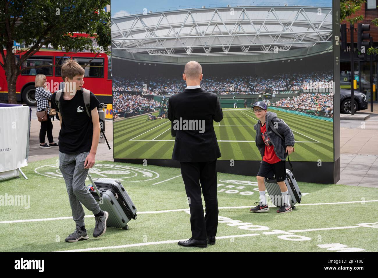 An image of the Lawn Tennis Association's Centre Court is located in front of Wimbledon train station where the public walk past during the two-week championships, on 30th June 2022, in London, England. Stock Photo