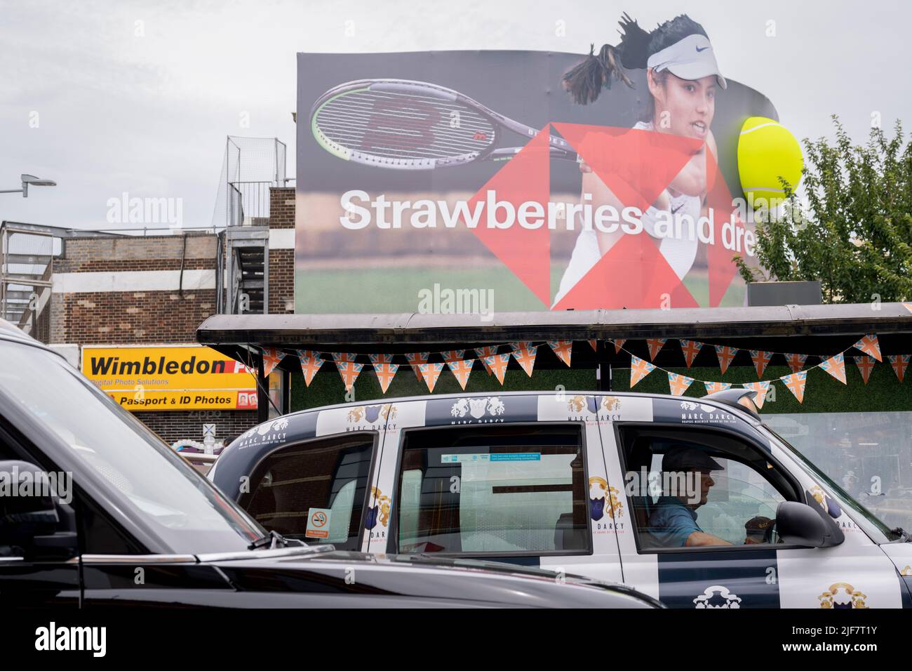 British tennis player, Emma Raducanu who is sponsored by HSBC appears on a giant billboard in Wimbledon town centre, during the first week of competition of the Wimbledon Lawn Tennis Association championships, on 30th June 2022, in London, England. Raducanu, whose parents both work in the financial industry, already has sponsorship deals with Porsche, Tiffany and Co, British Airways, Evian, Dior and Vodafone. HSBC is also a major Wimbledon sponsor but a UK parliamentarian group has called on Wimbledon to drop the brand over the bank’s support of the controversial national security law in Hong Stock Photo