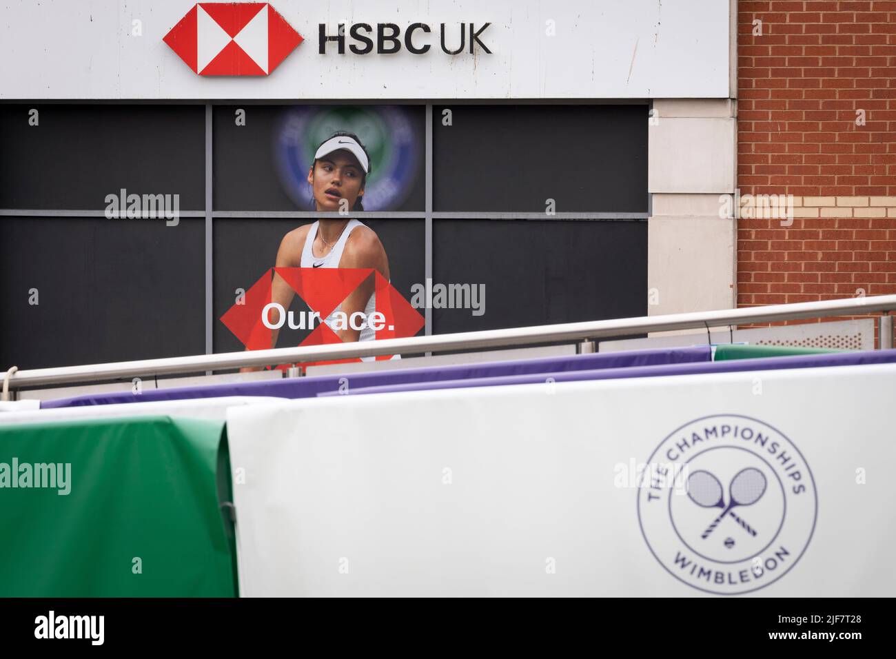 British tennis player, Emma Raducanu who is sponsored by HSBC appears on a giant billboard in Wimbledon town centre, during the first week of competition of the Wimbledon Lawn Tennis Association championships, on 30th June 2022, in London, England. Raducanu, whose parents both work in the financial industry, already has sponsorship deals with Porsche, Tiffany and Co, British Airways, Evian, Dior and Vodafone. HSBC is also a major Wimbledon sponsor but a UK parliamentarian group has called on Wimbledon to drop the brand over the bank’s support of the controversial national security law in Hong Stock Photo