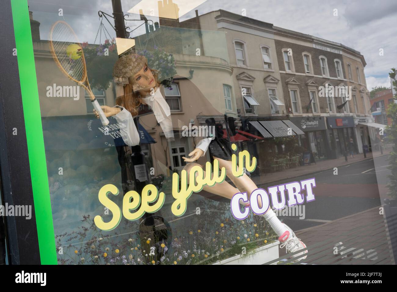 A Wimbledon tennis theme pun is seen in the window of a solicitor's busines in  Wimbledon Village during the Lawn Tennis Association's two-week championships, on 30th June 2022, in London, England. Stock Photo