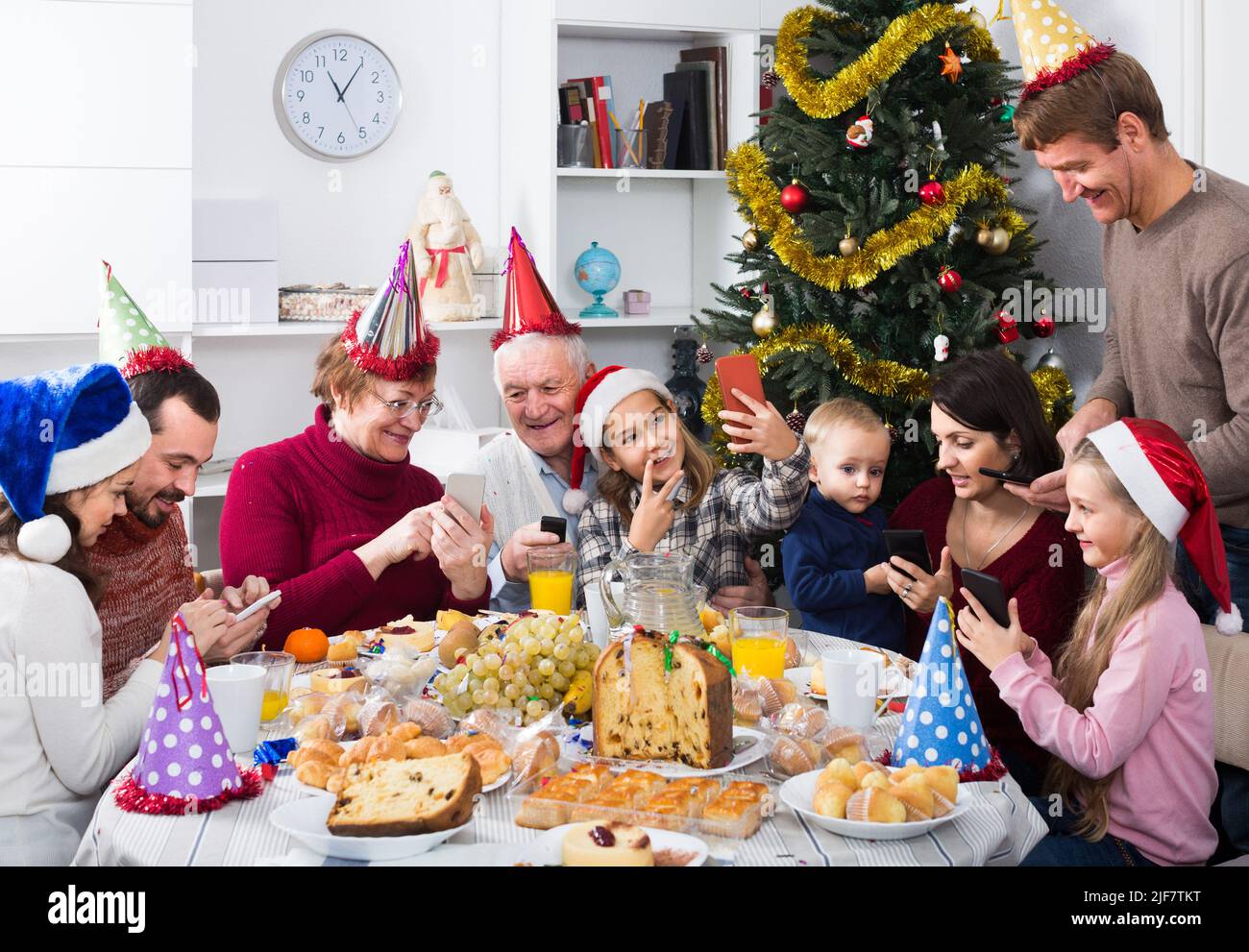 Large family making numerous photos during Christmas dinner Stock Photo