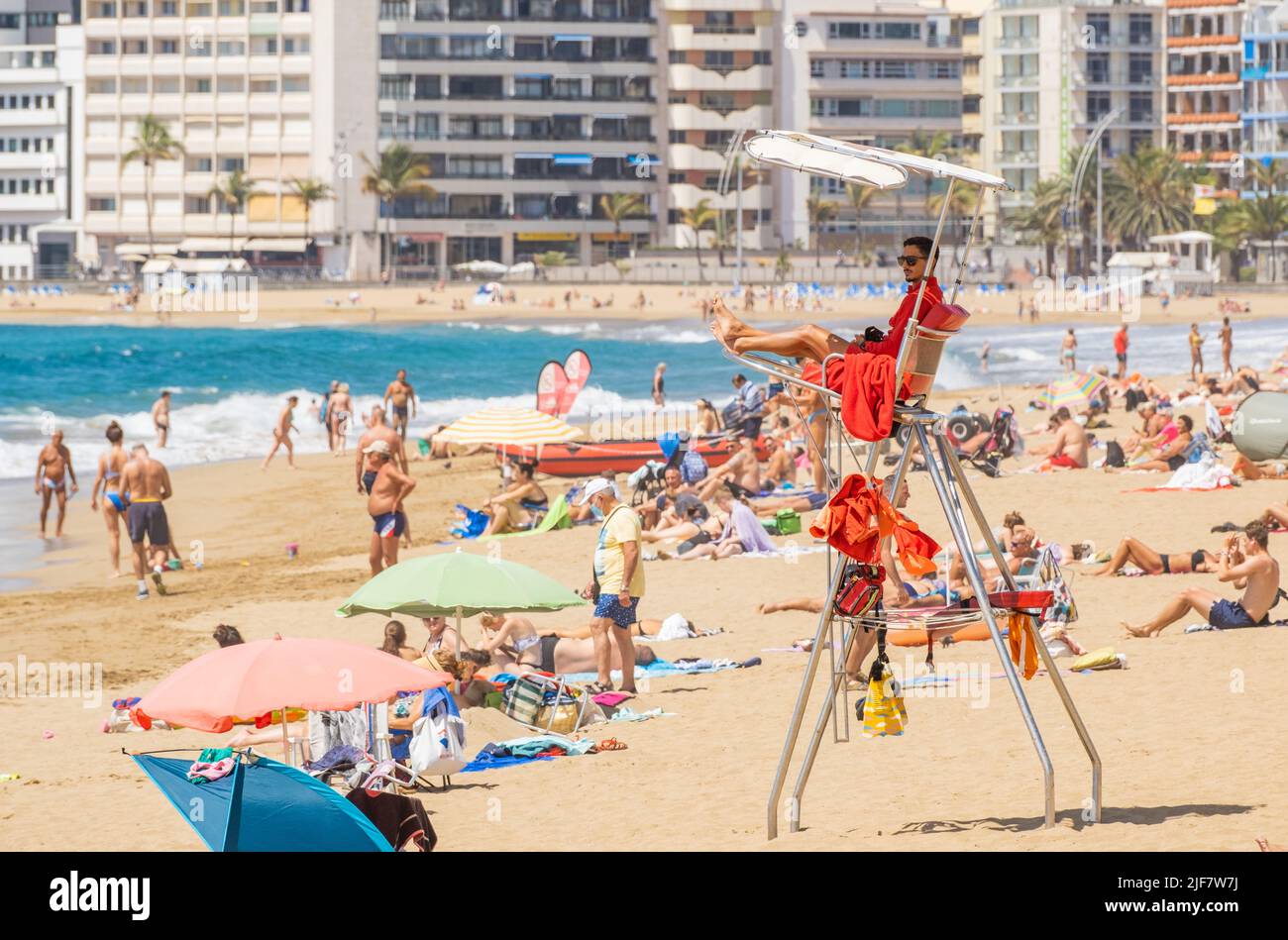 Las Palmas, Gran Canaria, Canary Islands, Spain. 30th June, 2022. Tourists, many from the UK, bask on the city beach in Las Palmas on Gran Canaria; a popular holiday destination for many UK holidaymakers. Credit: Alan Dawson/ Alamy Live News. Stock Photo