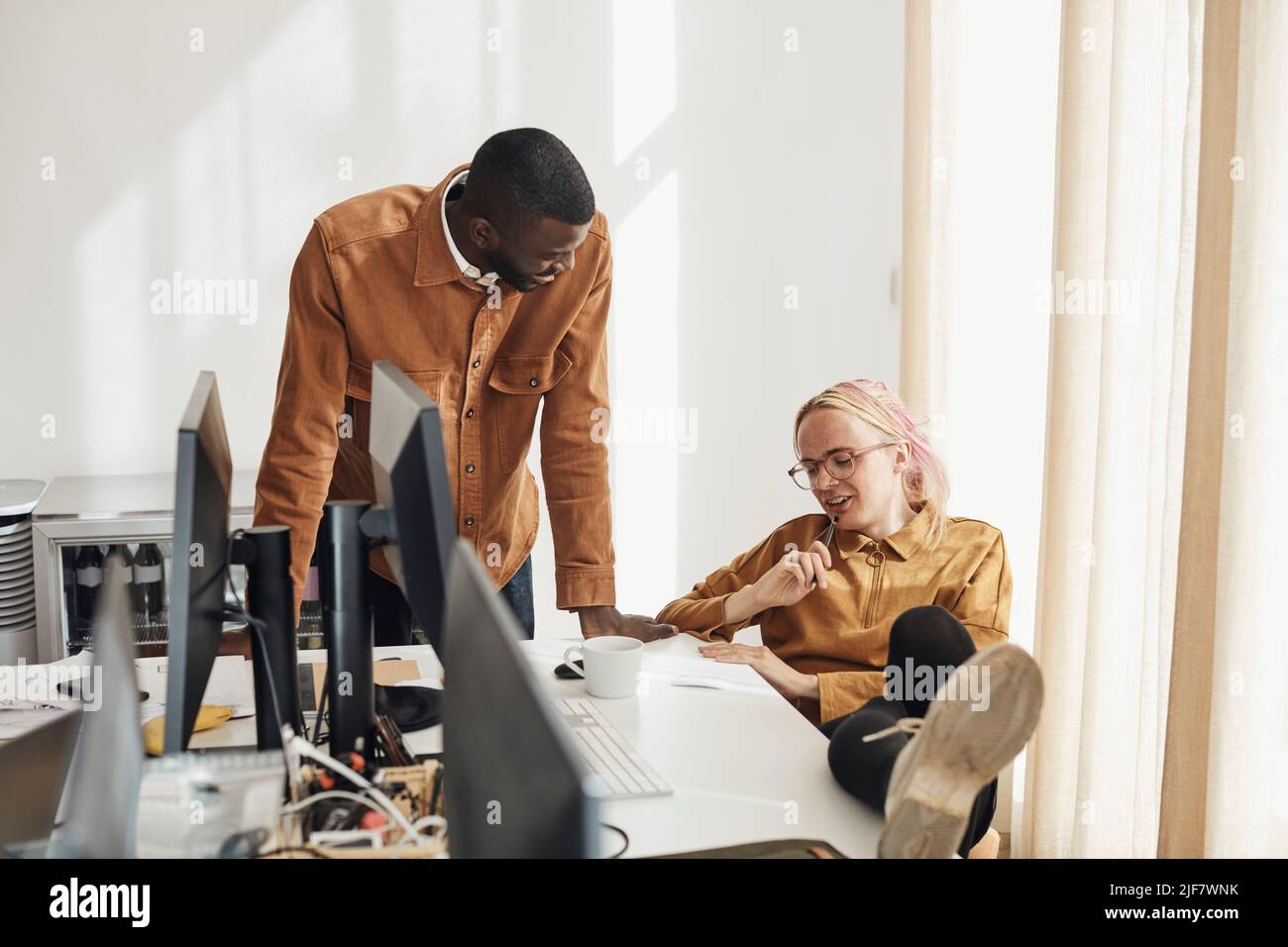 Entrepreneurs discussing over document while planning strategy during meeting in office Stock Photo