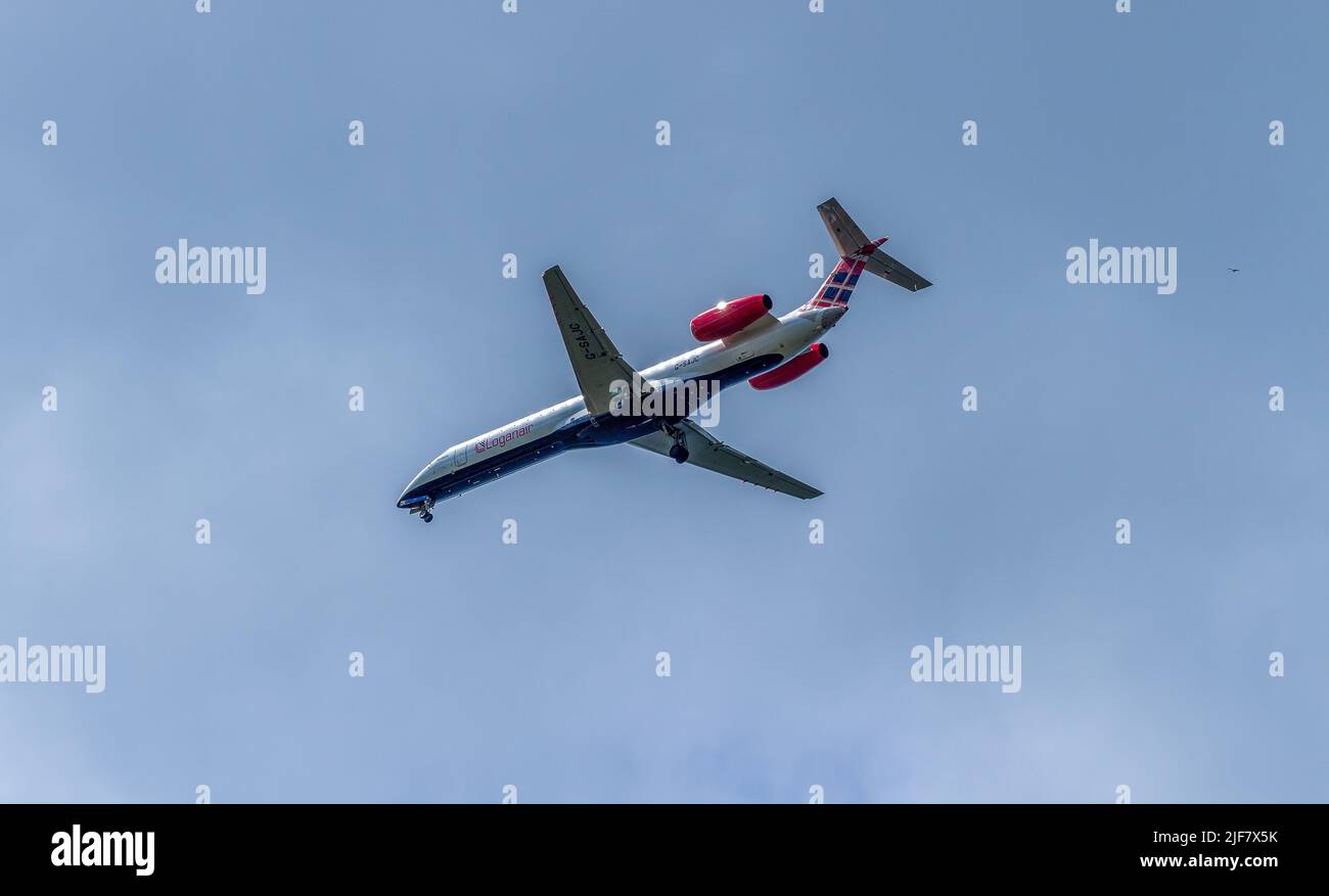 Returning Logan Air Flight flying overhead in Edinburgh, Scotland Stock Photo