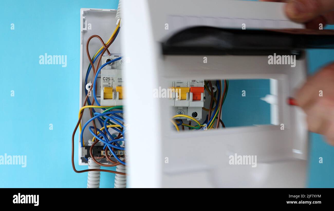 Repairing of electrical panel with fuse box in home wiring system Stock