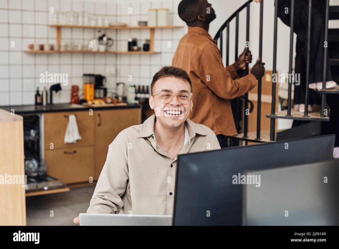 Portrait of happy male computer programmer sitting in office Stock ...