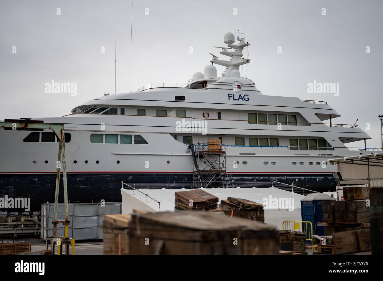 luxury yacht under maintenance, they are painting the hull Stock Photo