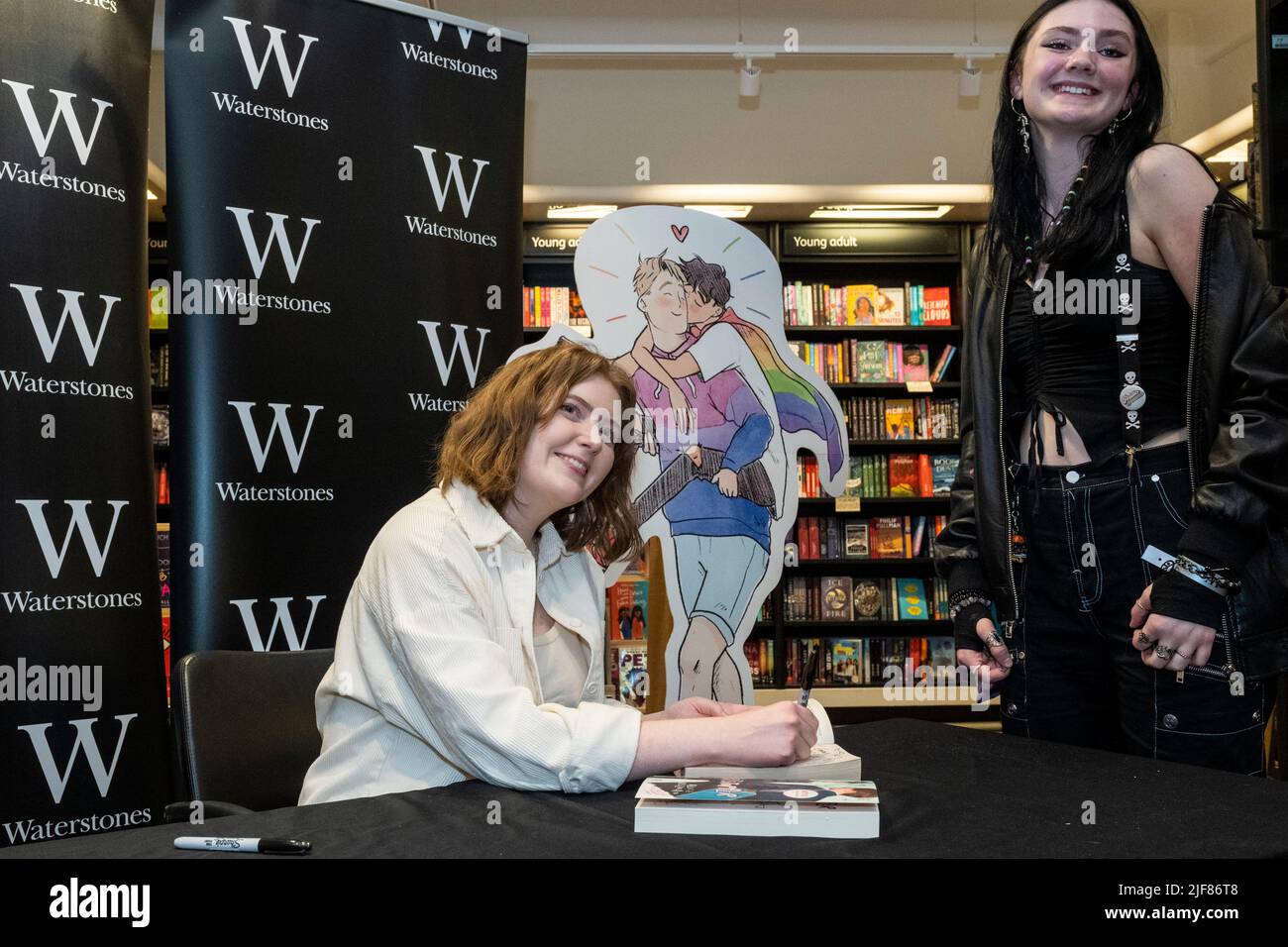 London, UK. 30 June 2022. Writer Alice Oseman (L) with a fan at a