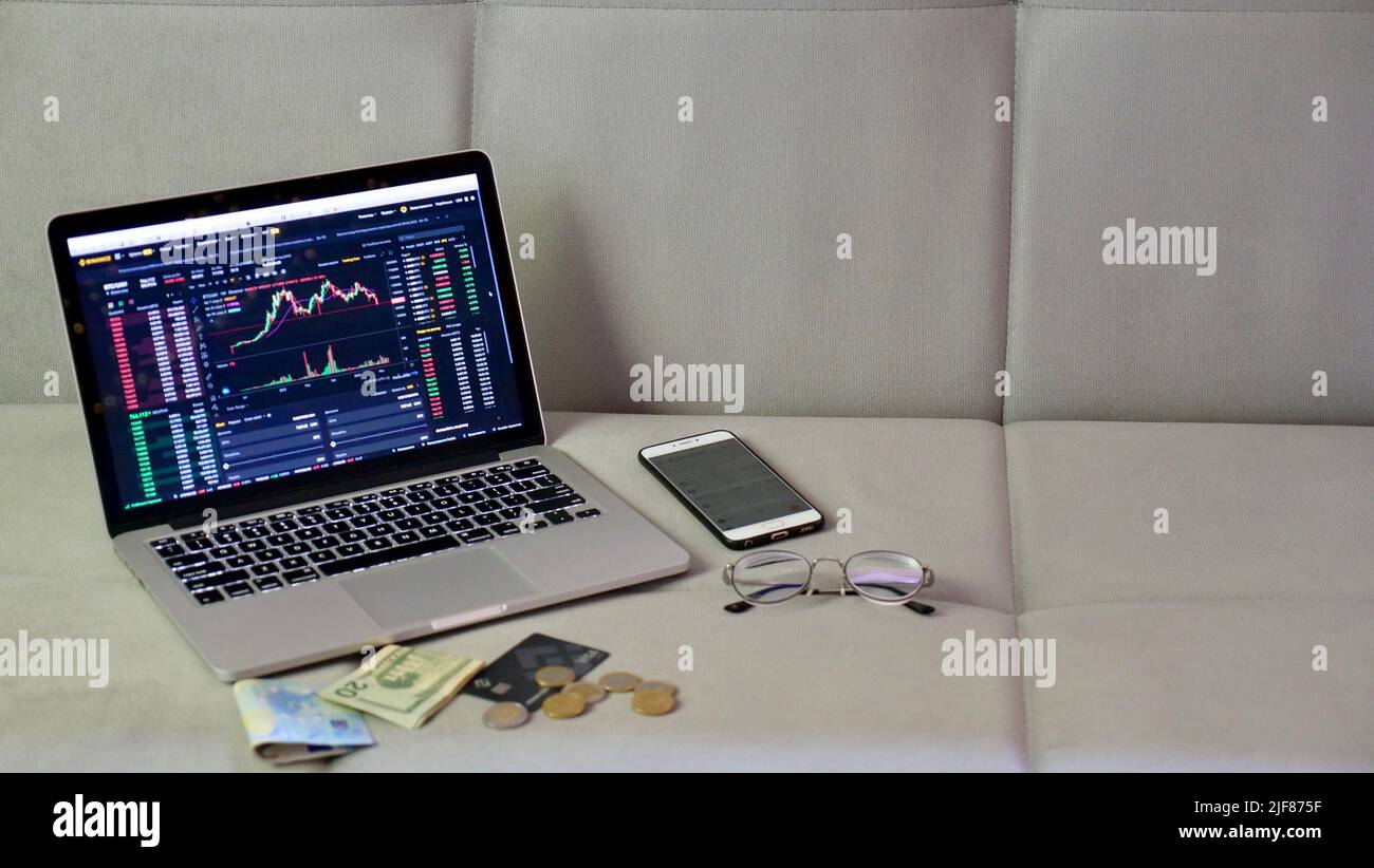 Laptop and phone to buy bitcoin on the Binance crypto exchange during the  market crash. Trading, spot, staking. Workspace freelance flatlay with bank  card Stock Photo - Alamy