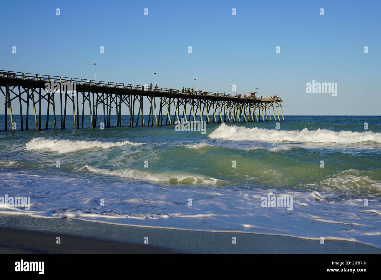 Waves on the beach at Kure Beach Pier on the North Carolina coast Stock Photo
