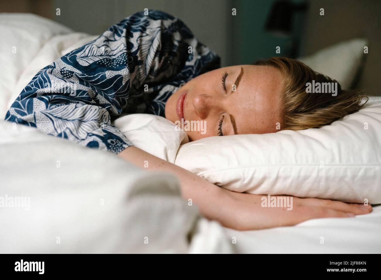 Woman sleeping on bed in bedroom at home Stock Photo Alamy