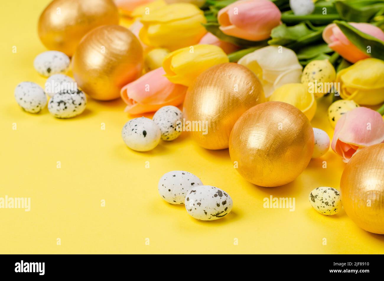 nest with gold decorative eggs and feathers in the nest on a gold ...