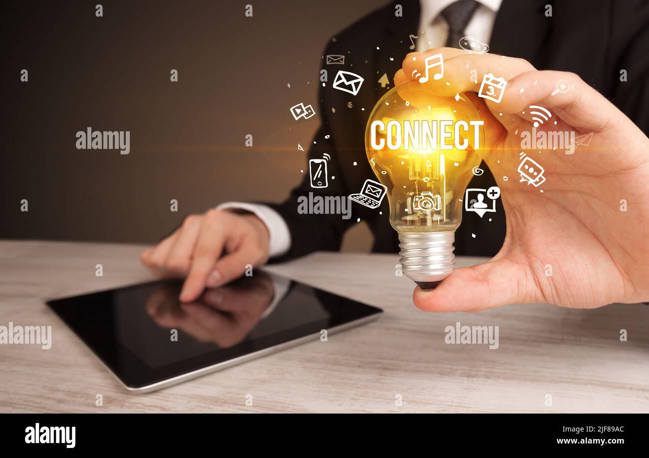 Businessman holding a light bulb, social media concept Stock Photo - Alamy