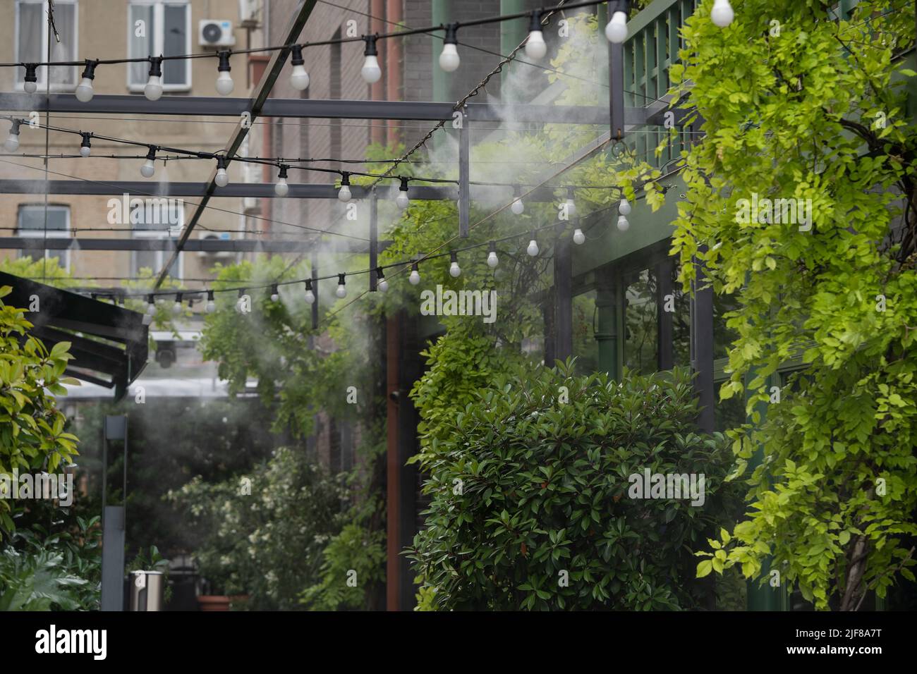 Water spray system to create a humidifier and cooling climate to reduce