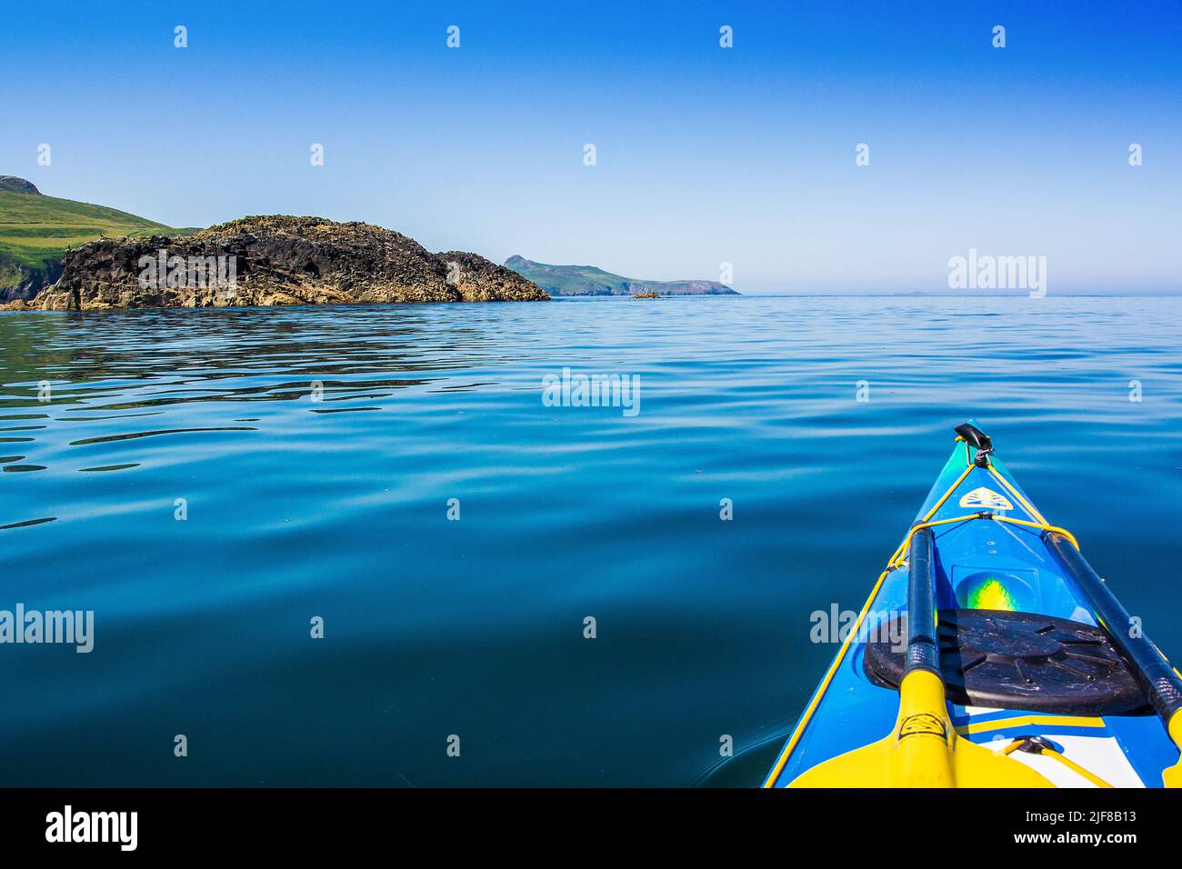 Sea kayaking off St Davids Head  on the Pembrokeshire Coast in Wales Stock Photo
