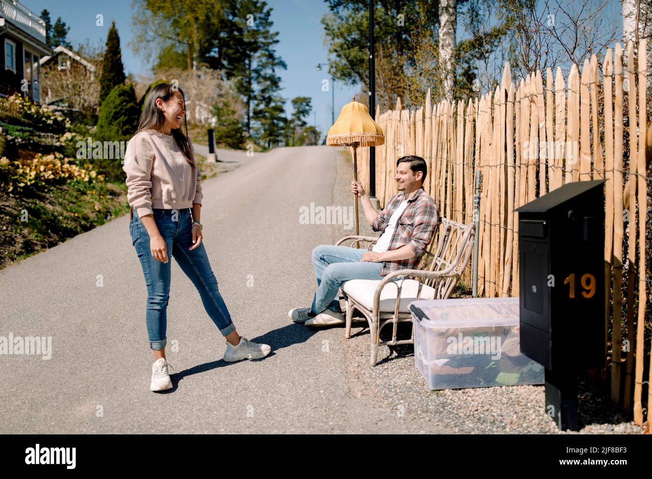 Smiling couple taking break while relocating to new house Stock Photo