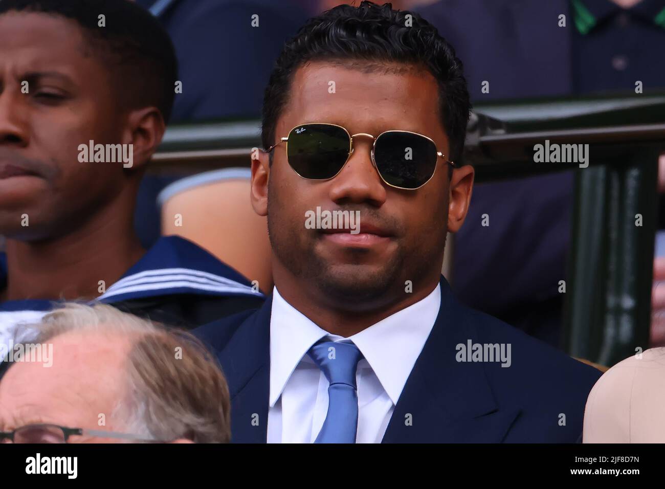 Denver Broncos quarterback Russell Wilson tosses out the first pitch during  ceremonies to mark the regular-season home opener as the Colorado Rockies  host the Los Angeles Dodgers in a baseball game Friday