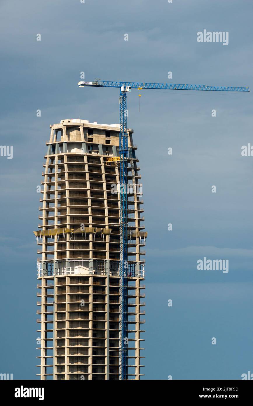 High rise development and under construction site with tower crane Stock Photo