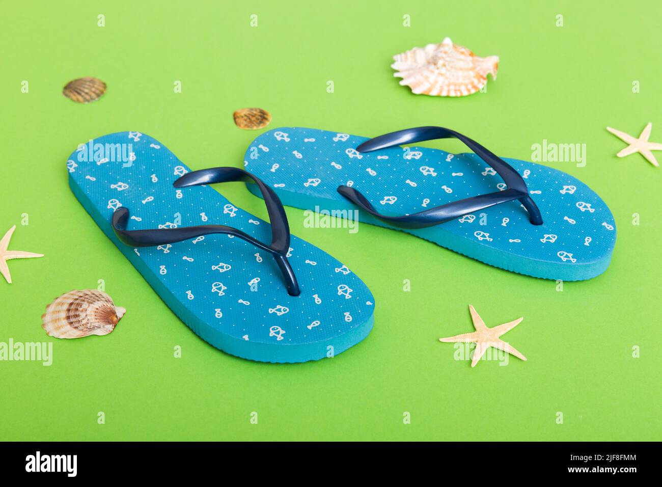 Beach accessories. Flip flops and starfish on colored background. Top ...