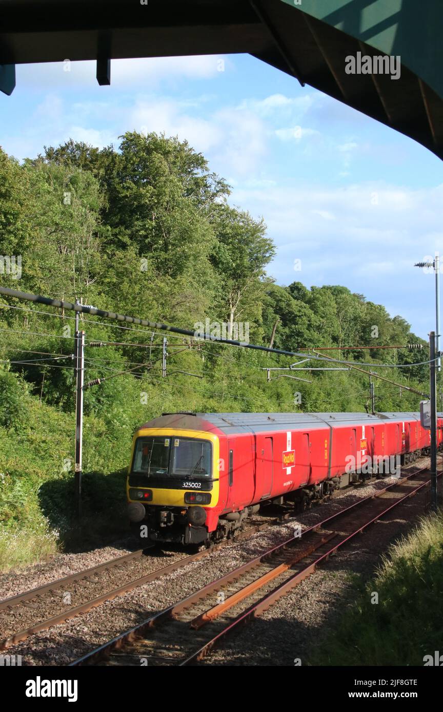 Royal mail train on West Coast Main Line railway in countryside near Scorton in Lancashire on 30th June 2022 with Anglo Scottish service. Stock Photo