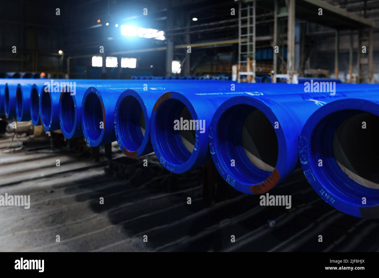 New cast iron pipes for pipeline construction in warehouse Stock Photo