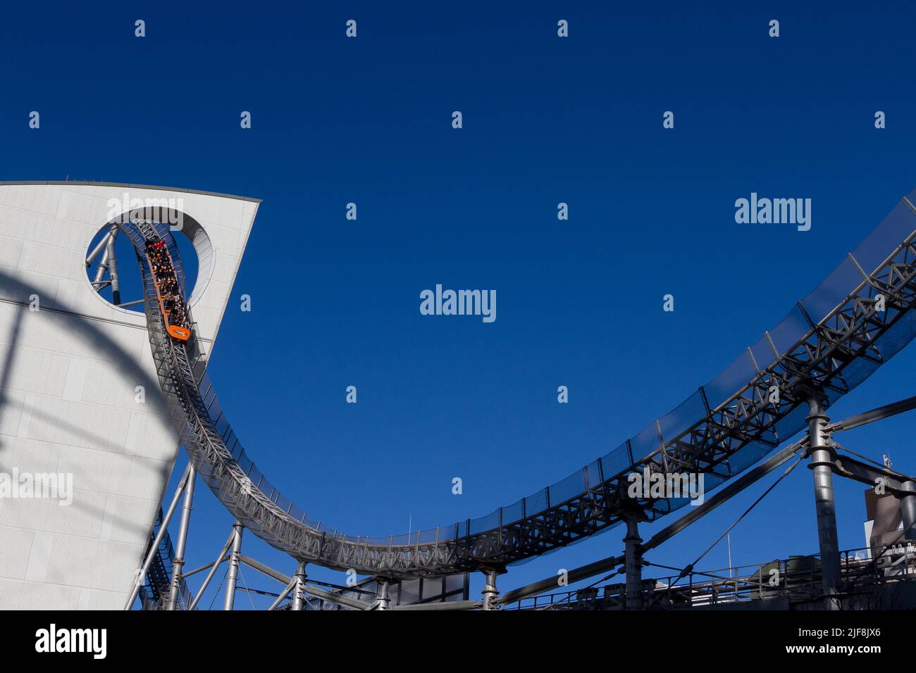The Thunder Dolphin rollercoaster goes through a hole in the LaQua building in Tokyo Dome City amusement park , Tokyo, Japan. Stock Photo