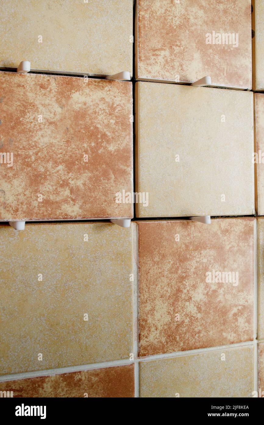 Laying ceramic tiles on a special cement mortar with the help of