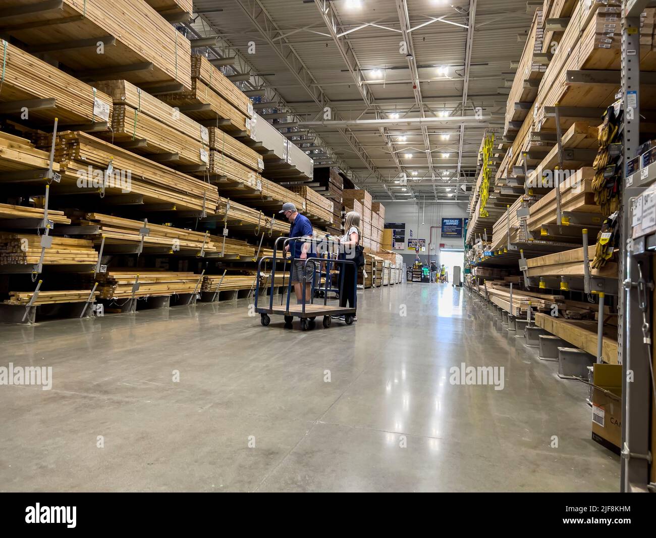 Mill Creek, WA USA - circa June 2022: View of a couple shopping for lumber inside a Lowe's home improvement store. Stock Photo