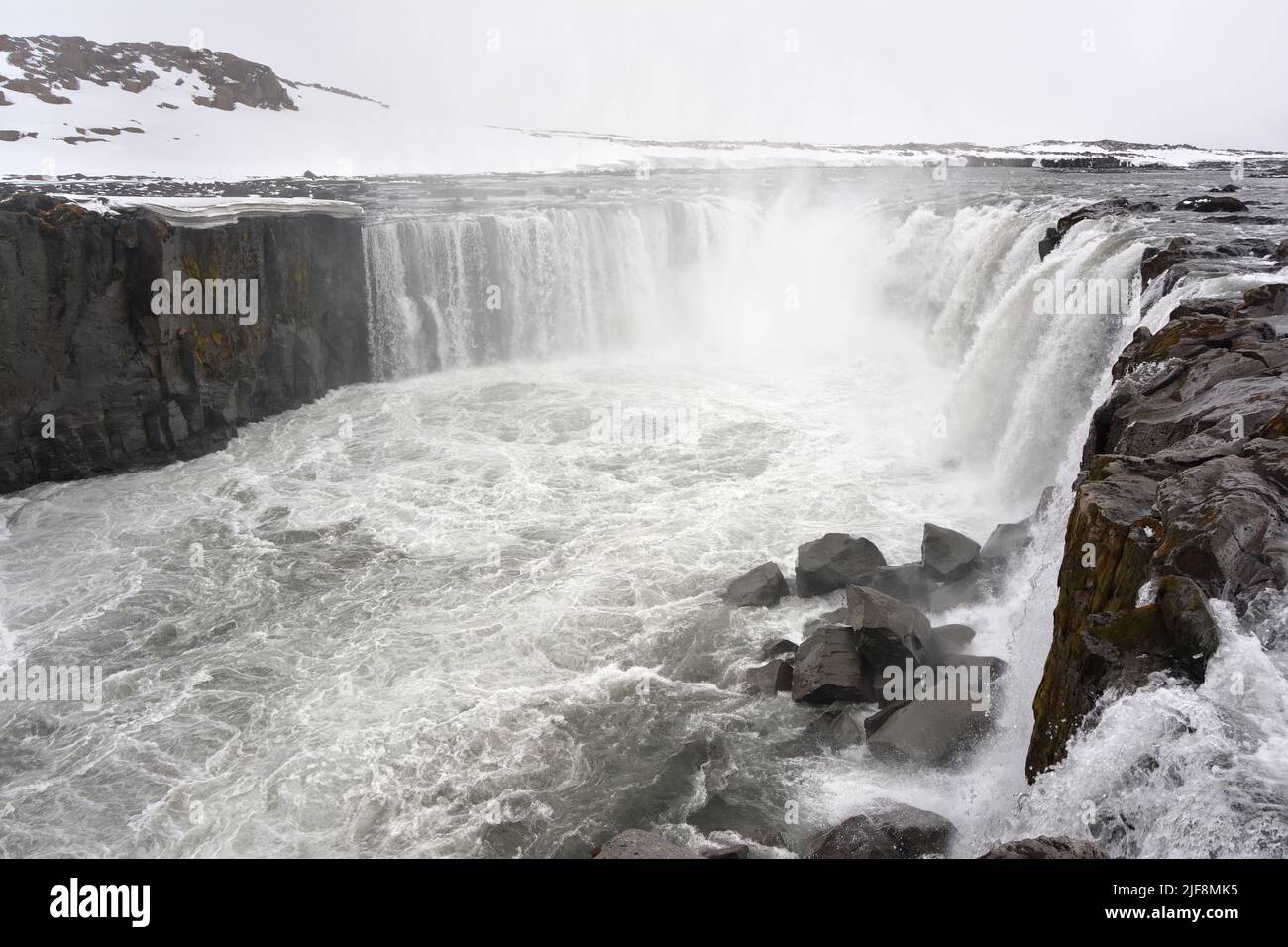 Selfoss waterfall with snow in the background. Jökulsárgljúfur national park, Iceland Stock Photo