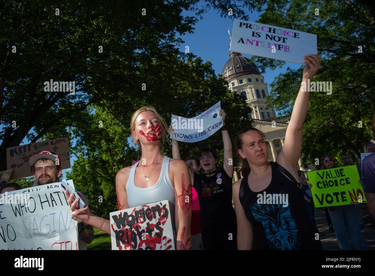 Topeka, Kansas, USA. 29th June, 2022. KAYLEE CLEAVER, second from left, stands with protesters