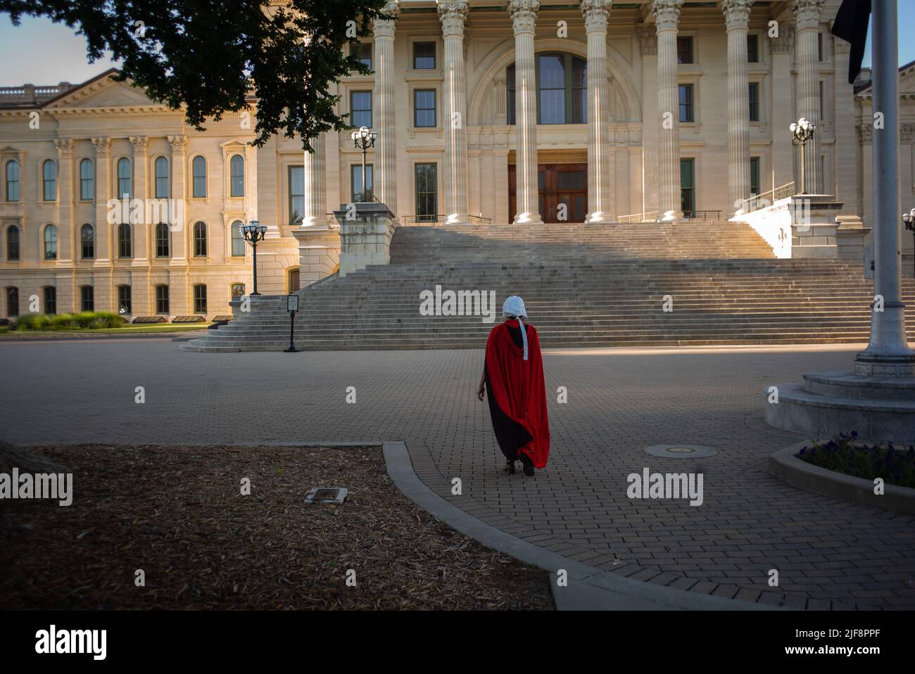 Topeka, Kansas, USA. 29th June, 2022. KRYSTEA CASTRO, walks up the steps of the Kansas State Capitol building while dressed as a Handmaid. Pro-choice activists protest at the Kansas State Capitol Building on Wednesday following the US Supreme Court overturning of Roe v Wade. (Credit Image: © Luke Townsend/ZUMA Press Wire) Stock Photo