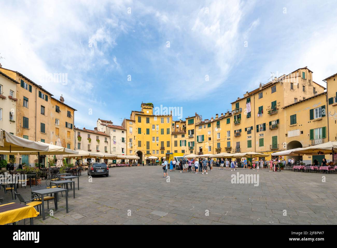 Sidewalk cafes inside the the Piazza del Anfiteatro, the ancient amphitheater in the Tuscan walled town of Lucca, Italy. Stock Photo