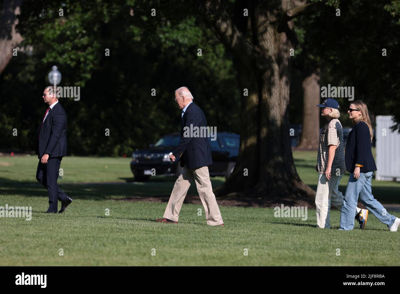 United States President Joe Biden, arrives on the South Lawn of the White House alongside his 2 granddaughters, Finnegan Biden and Maisy Biden, on June 30, 2022 in Washington, DC. Biden returned to Washington after attending summits in Germany and Spain.Credit: Oliver Contreras/Pool via CNP /MediaPunch Stock Photo