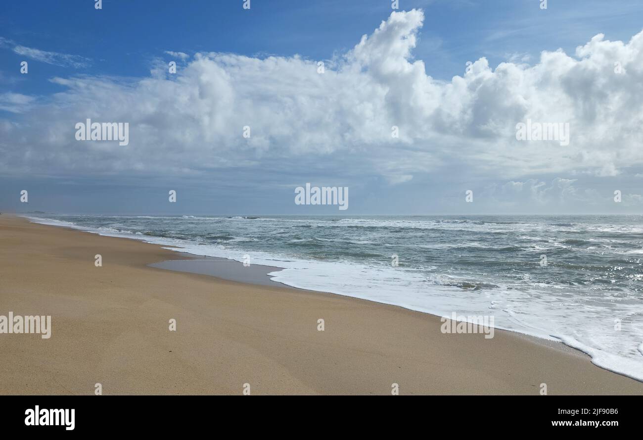 Empty, unspoiled beach at Cape Hatteras National Seashore in North Carolina with clouds overhead. Stock Photo