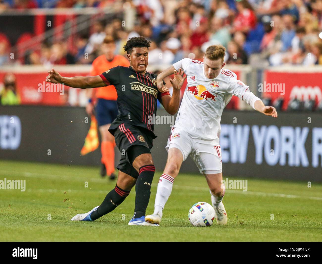 Harrison, NJ, USA. 30th June, 2022. Atlanta United defender Caleb Wiley (26) and New York Red Bulls forward Cameron Harper (17) battle for the ball during a MLS game between the Atlanta United FC and the New York Red Bulls at Red Bull Arena in Harrison, NJ. New York defeated Atlanta 2-1. Mike Langish/Cal Sport Media. Credit: csm/Alamy Live News Stock Photo