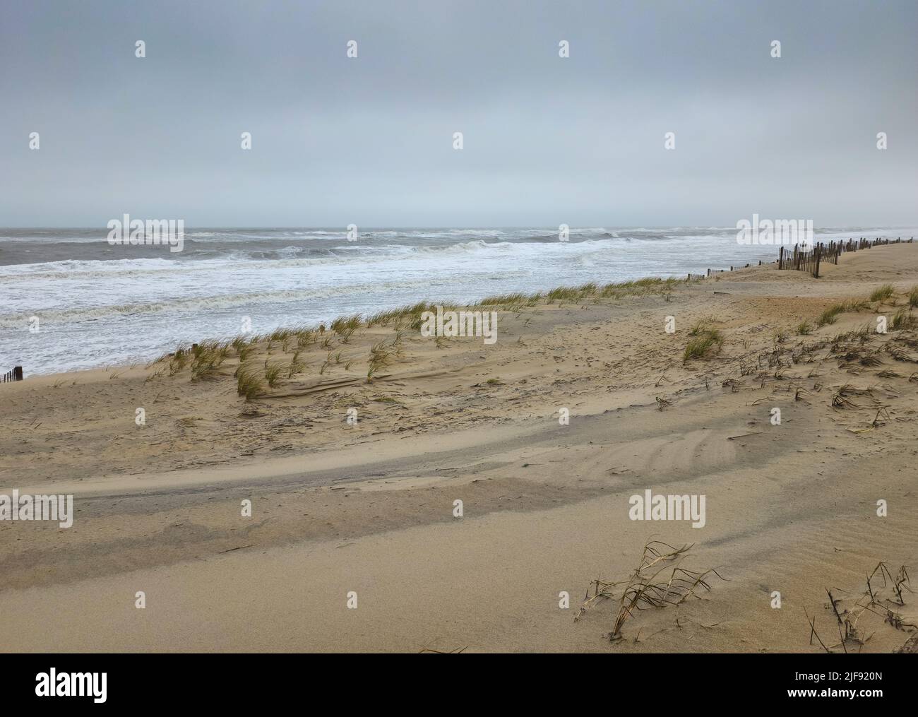 Nags Head Beach in Outer Banks, North Carolina during stormy weather with rough Atlantic Ocean and clouds overhead. Stock Photo