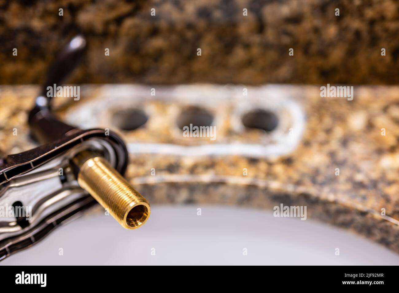 Replacing a bathroom sink faucet with a new assembly Stock Photo Alamy