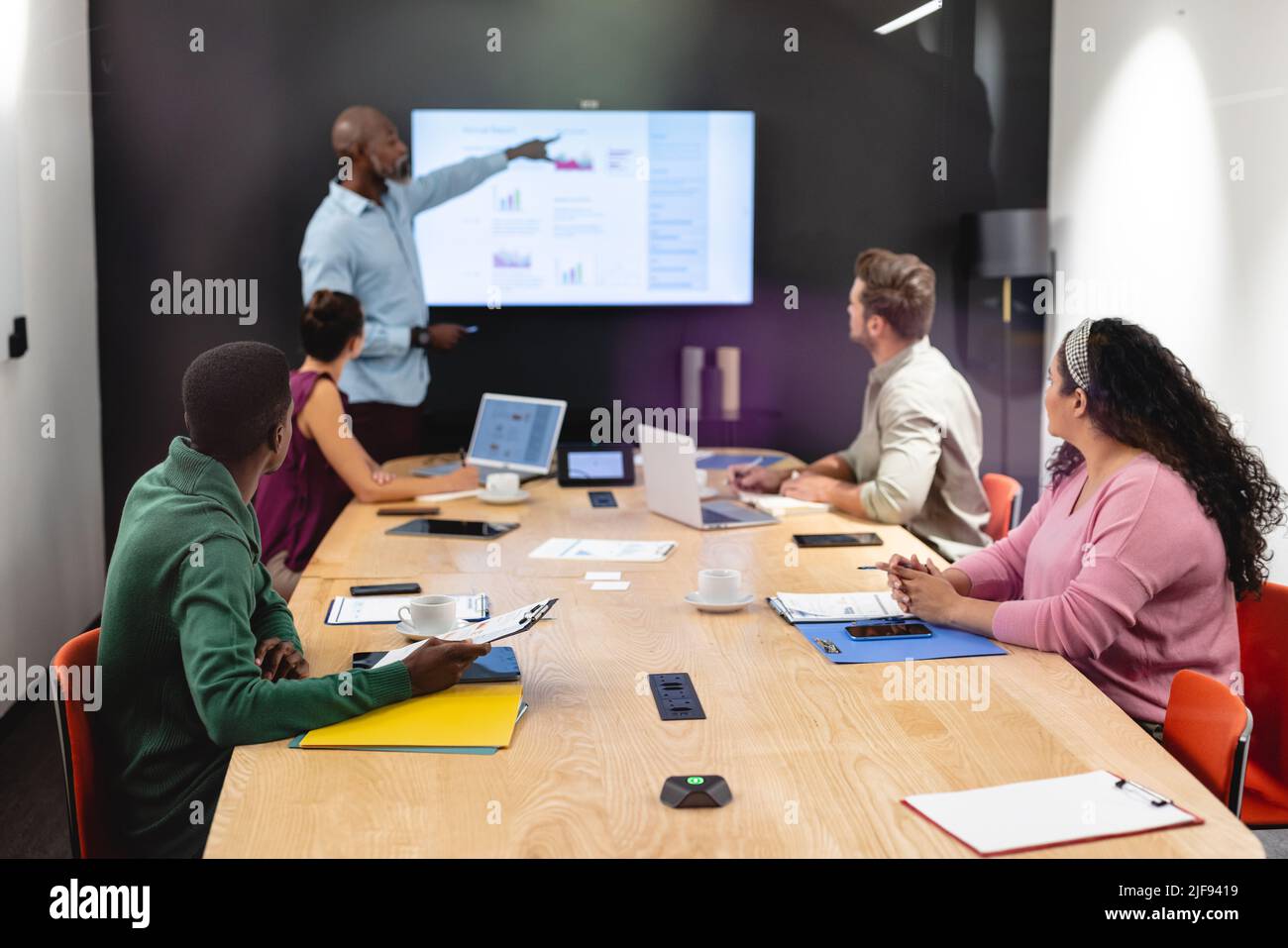 Businessman explaining business plan to multiracial colleagues in ...