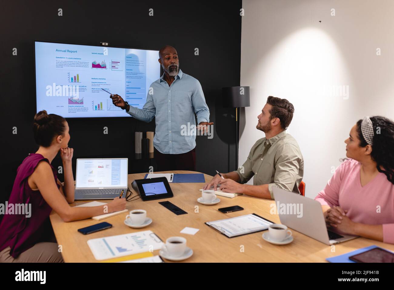 Businesswoman explaining business plan to multiracial colleagues in ...
