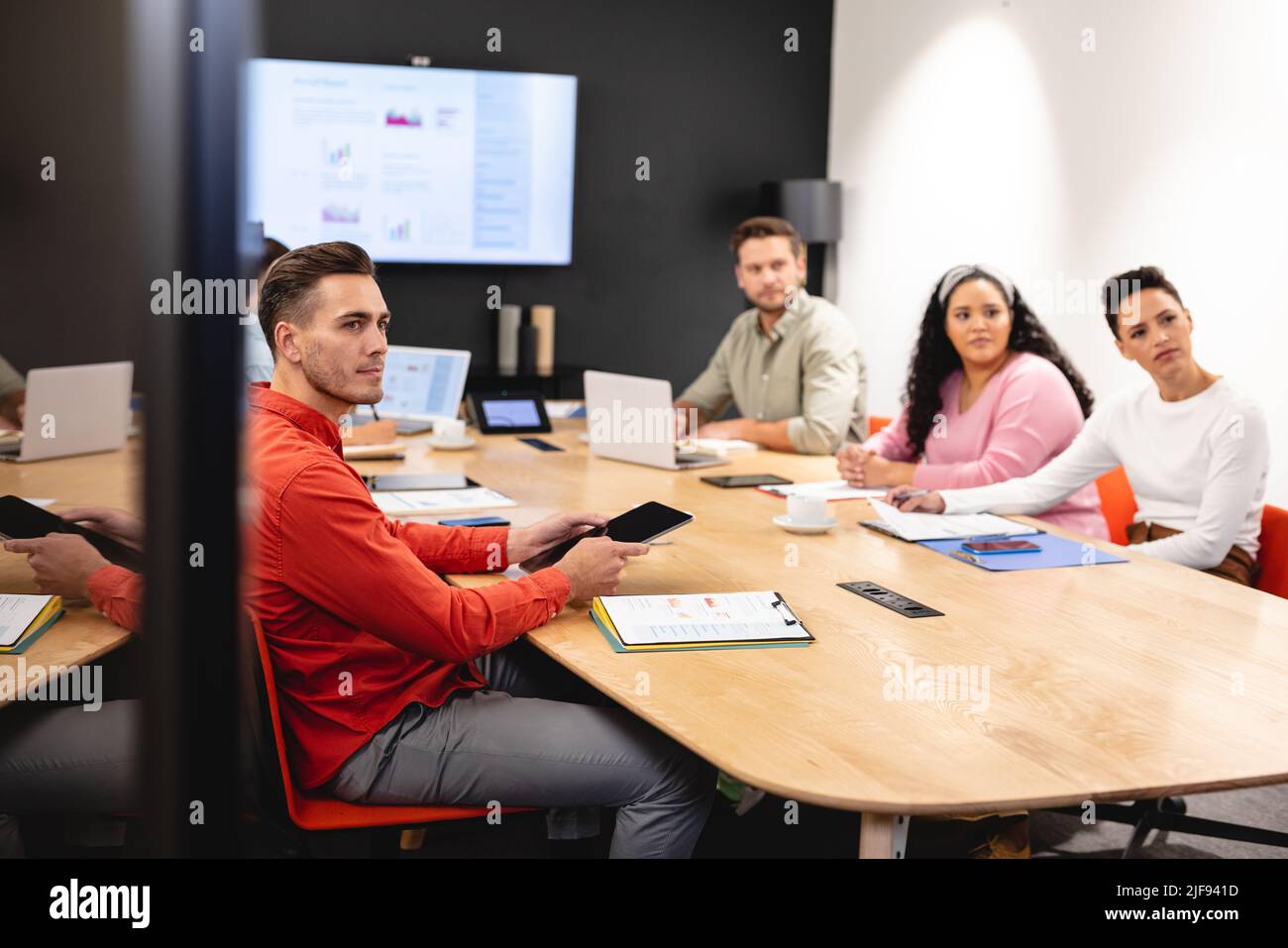 Multiracial businessman and businesswoman attending meeting in creative office Stock Photo