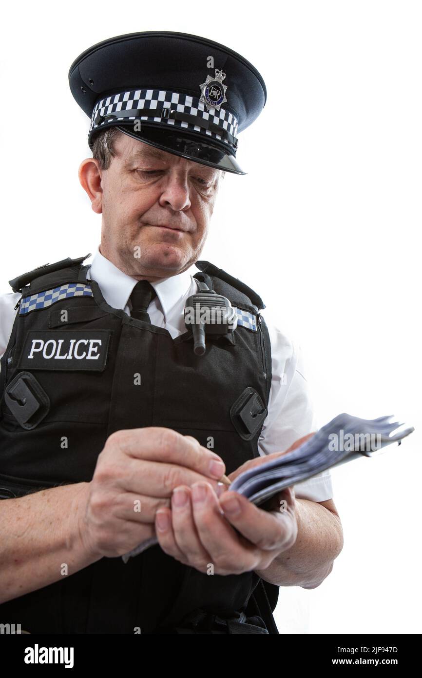 A UK uniformed policeman making notes in his notepad. Part of a series of images with the same character model. Stock Photo